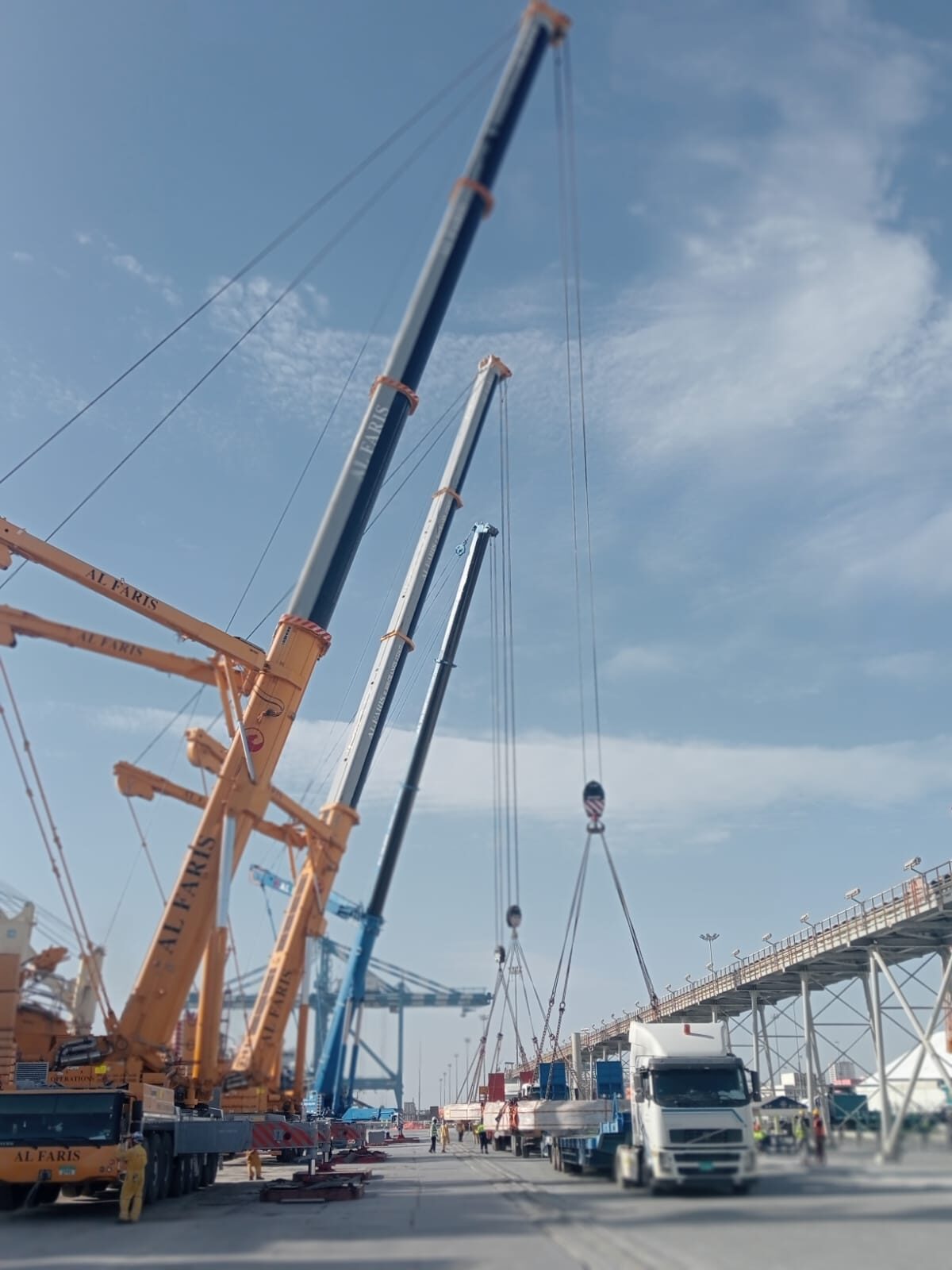 Crews working a tandem lift on the quay
